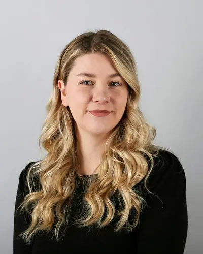 Original photo: a young woman with blonde wavy hair in a black top