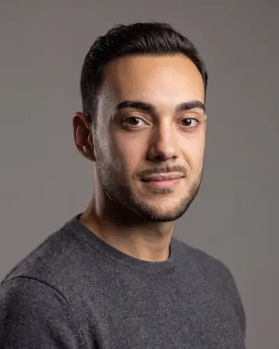 AI example made from that photo: the same man in a gray sweater on a gray background