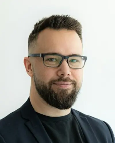 Original photo: a bearded man with glasses in a black blazer