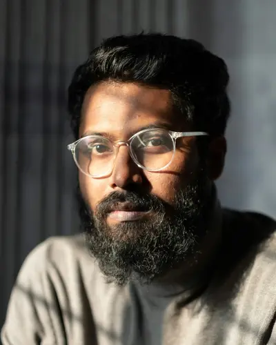 Original photo: a bearded man with glasses in a gray sweater