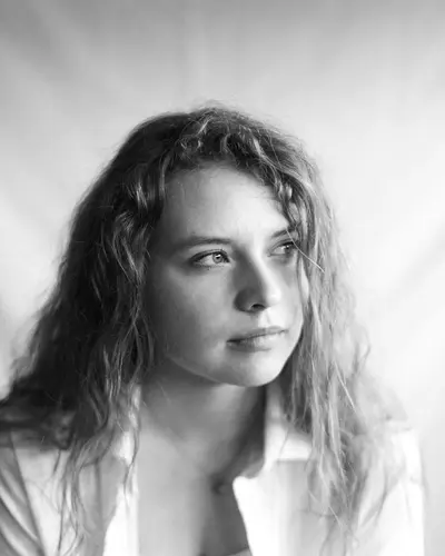 Original photo: a young woman with curly hair, black and white photo